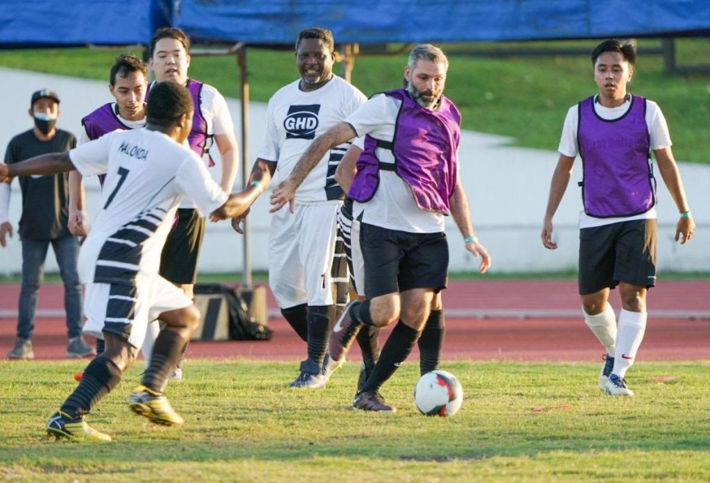 Midfielder Lucas Blanco (in purple vest) dribbling past opponents